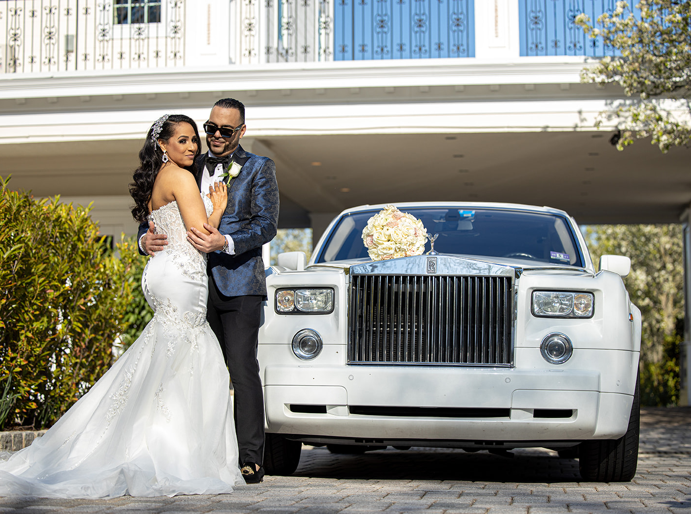Bride and Groom posing next to a car at The Wedding